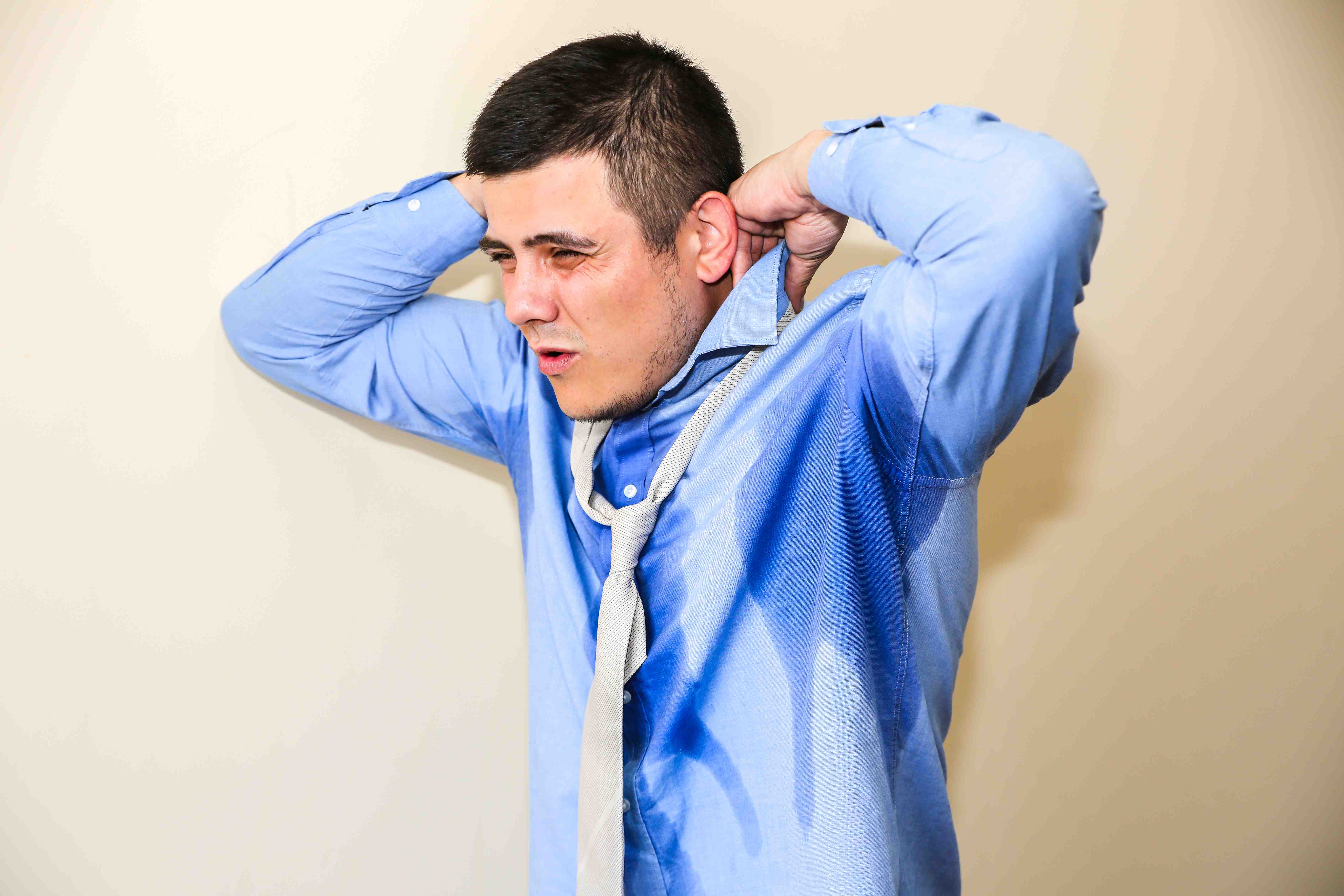 Frustrated man facing excessive sweating