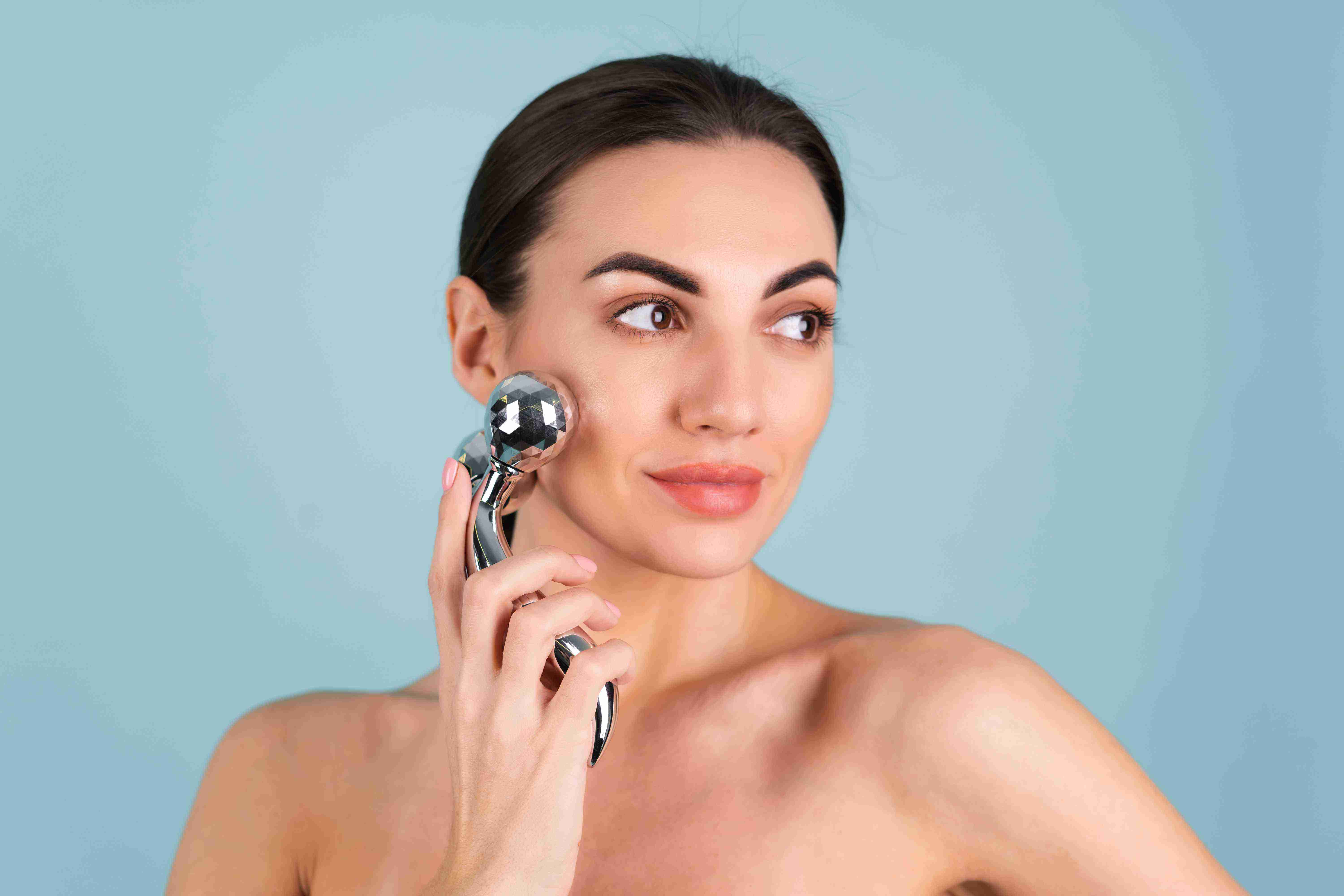 Woman using facial massage tools
