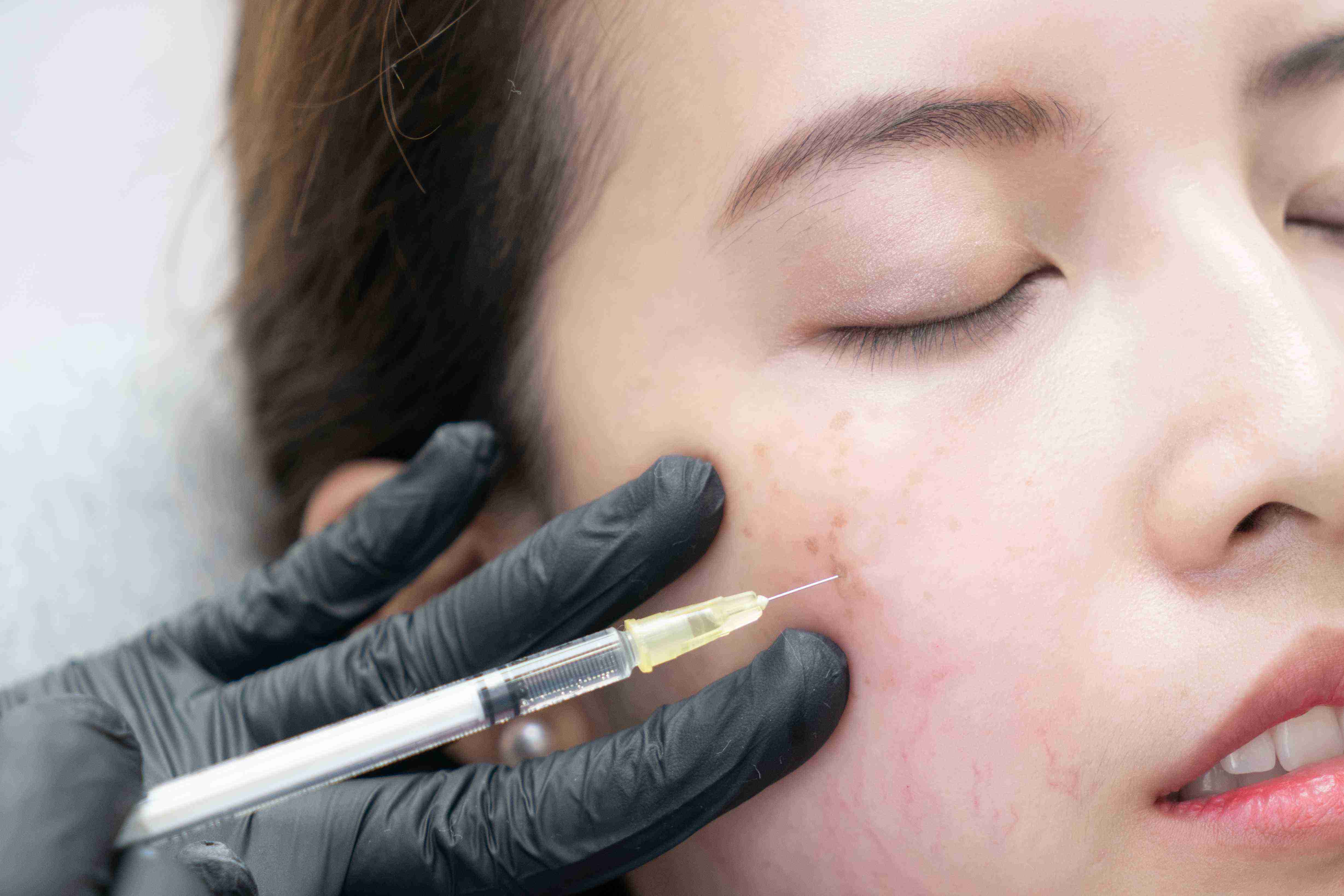 Woman using facial massage tools